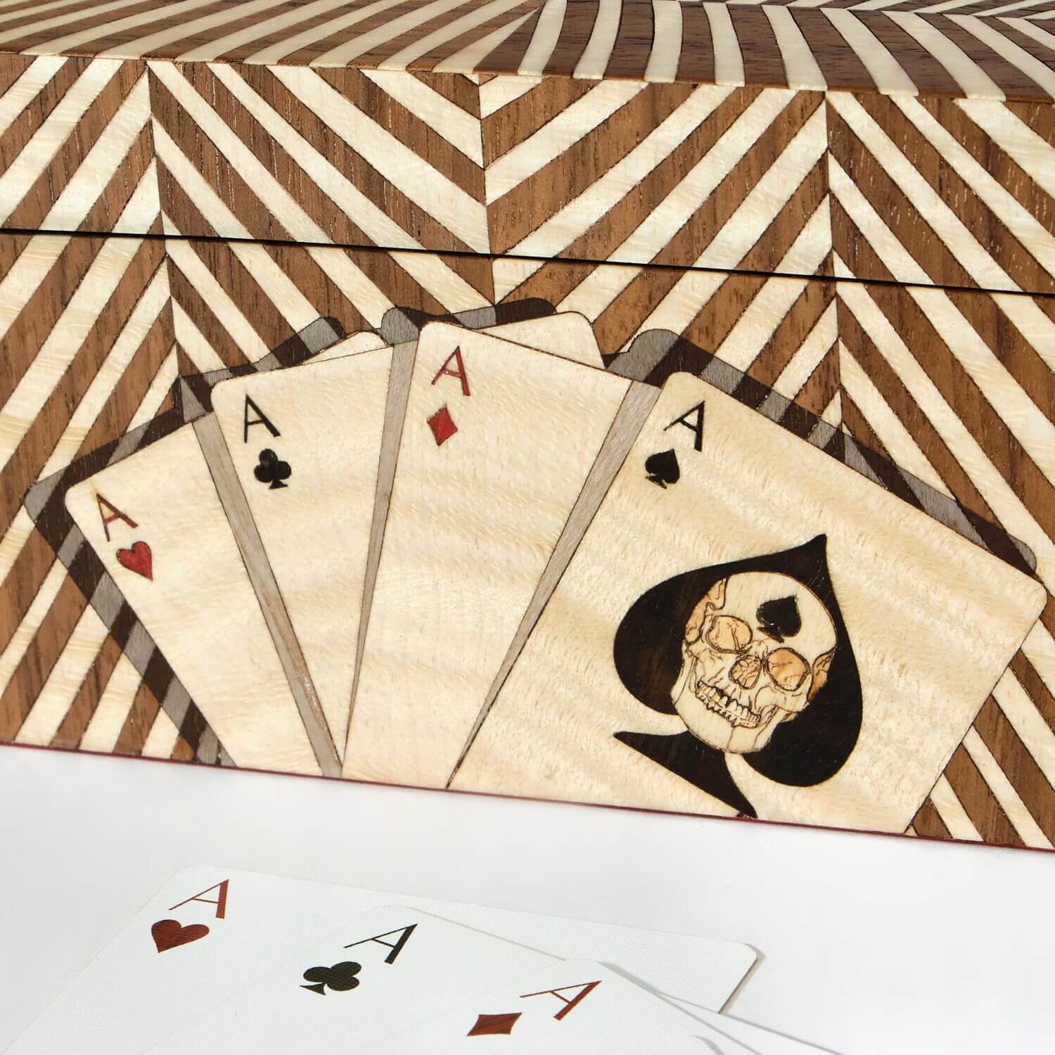A trompe l’oeil technique created in wood marquetry creating the illusion of shadow behind marquetry playing cards on the Double Cards Box side